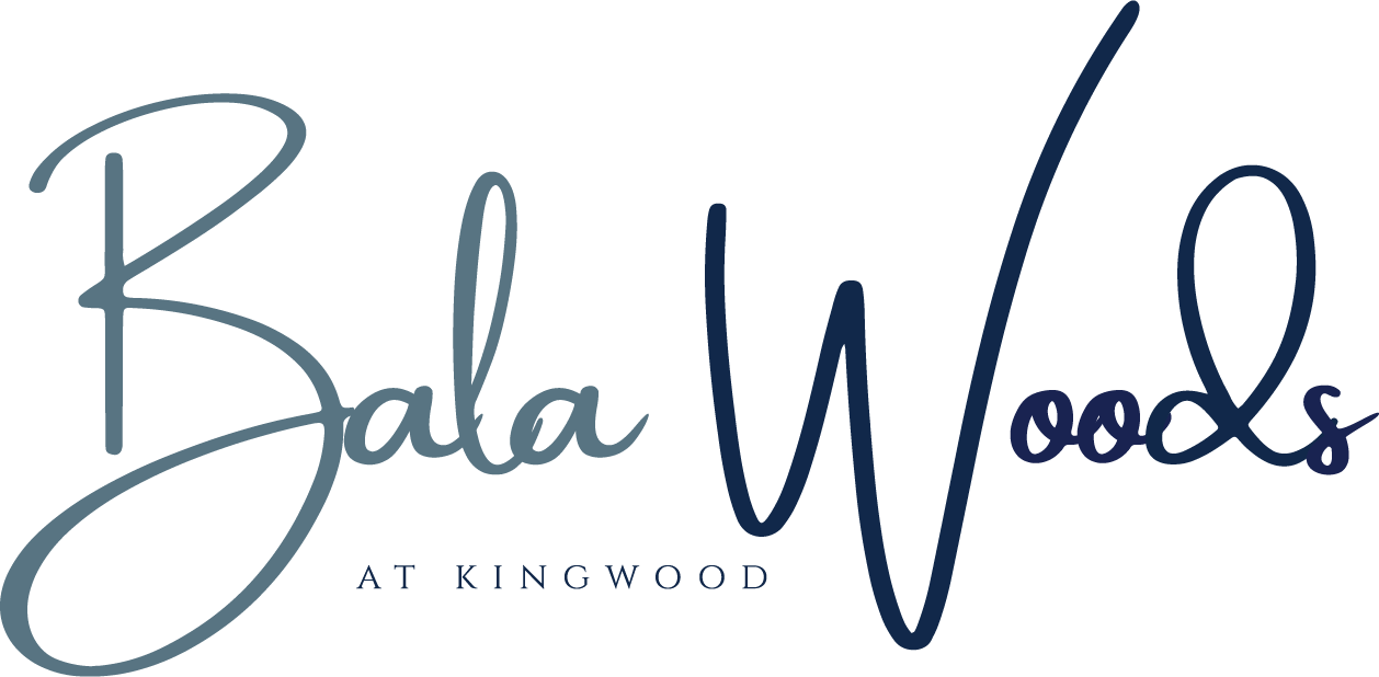 A logo with the text "Bala Woods at Kingwood" written in cursive.